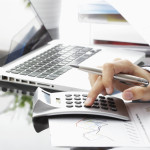 Man using calculator on desk