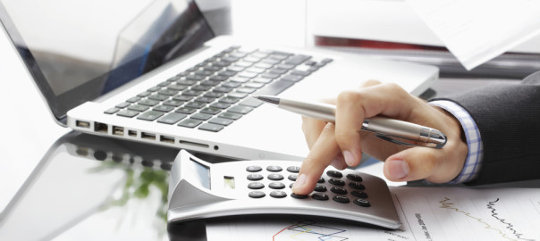 Man using calculator on desk